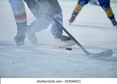 Ice Hockey Player In Action Kicking With Stick