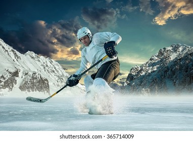 Ice Hockey Player In Action Outdoor Around Mountains