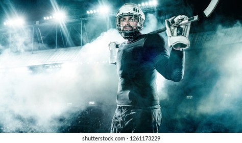 Ice Hockey player in the helmet and gloves on stadium with stick. - Powered by Shutterstock