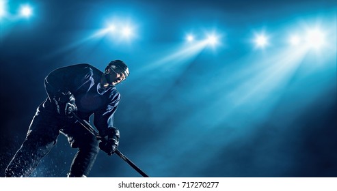 Ice Hockey player is skating on a abstract background with intensional lens flares. He is wearing unbranded sports clothes.