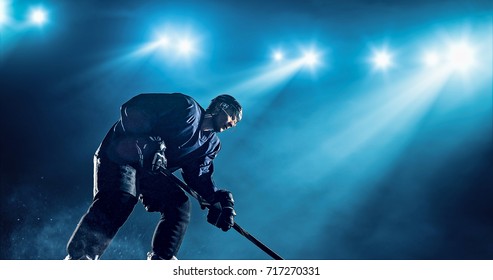 Ice Hockey player is skating on a abstract background with intensional lens flares. He is wearing unbranded sports clothes.