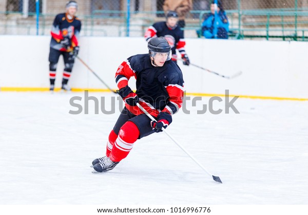 Ice\
hockey player with stick in attack. Ice hockey\
game