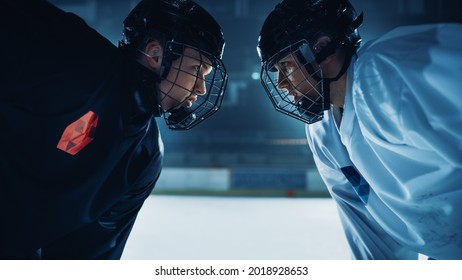 Ice Hockey Rink Arena Game Start: Two Professional Players Aggressive Face off, Sticks Ready. Intense Competitive Game Wide of Brutal Energy, Speed, Power, Professionalism. Close-up Portrait Shot
