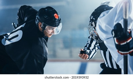 Ice Hockey Rink Arena Game Start: Two Professional Players Aggressive Face off, Sticks Ready. Referee Holds the Puck. Intense Competitive Game Wide of Brutal Energy. Close-up Portrait Shot.