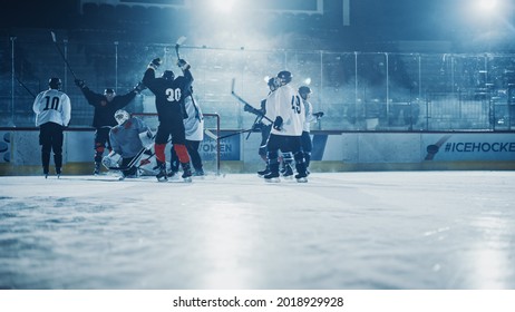 Ice Hockey Rink Arena: Professional Forward Player Broke Defense, Hit Puck With Stick And Scored A Goal, Goalie Missed It. Team Celebrates Victory.