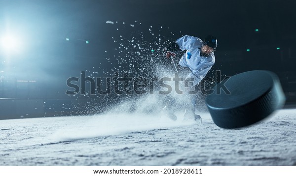 Ice Hockey Rink\
Arena: Professional Player Shooting the Puck with Hockey Stick.\
Focus on 3D Flying Puck with Blur Motion Effect. Dramatic Wide\
Shot, Cinematic Lighting.