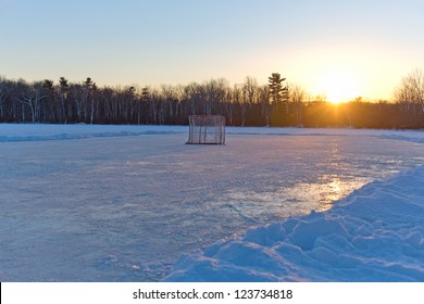 Ice hockey rink on frozen lake at sunset - Powered by Shutterstock