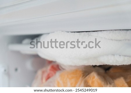 A lot of ice inside a fridge, freezer needs to be defrosted
