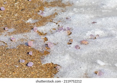 Ice Melt Salt Melting Ice And Snow On Sidewalk. Snow Removal, Melting Ice And Winter Weather Safety Concept