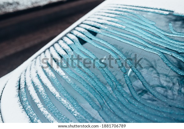Ice melts on the rear window of the car -\
electric window heating with contact\
strips