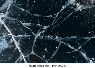 Ice on the Baikal lake. Beautiful cracked ice in winter close-up.