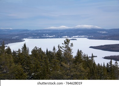 Ice On Rangeley Lake In Winter As Seen From The Summit Of Bald Mountain In Rangeley, Maine, With Snow Covered Mountains In The Distance.