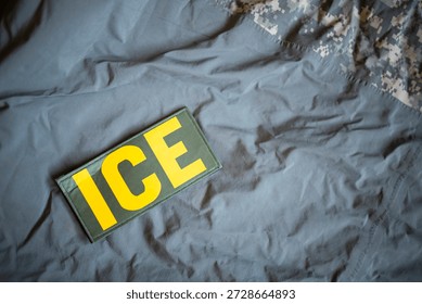 ICE patch on gray background.