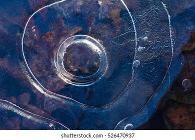 Ice pattern background on the surface of the pond or river. Macro frost crystal winter design