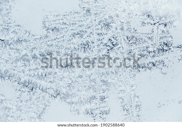 Ice\
patterns on frozen glass. Abstract ice pattern on winter glass as a\
background image. Copy, empty space for\
text.