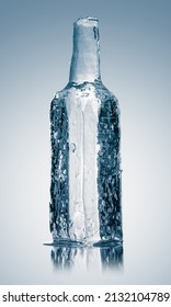 Ice Sculpture In Form Of A Glass Bottle, Made Of Textured Pure Ice On A White Reflective Surface.