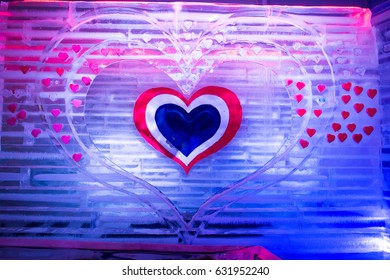 Ice Sculpture Heart. Colored Lights In Background.