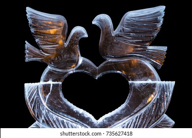 Ice Sculpture With A Heart And Doves. With The Flames Behind Warm.