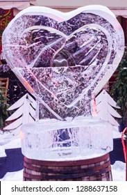 Ice Sculpture Heart In The Hands. Valentine's Day Art Concept.