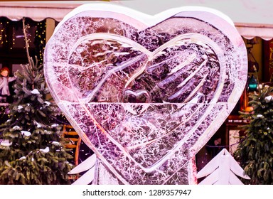 Ice Sculpture Heart In The Hands. Valentine's Day Art Concept.