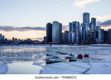 Ice sheets in harbor with city skyline and cloudy skies