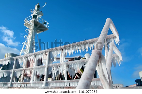 Ice of the ship and ship\
structures after sailing in frosty weather during a storm in the\
Pacific Ocean. Ice patterns and icicles, the play of light, ice and\
sun.