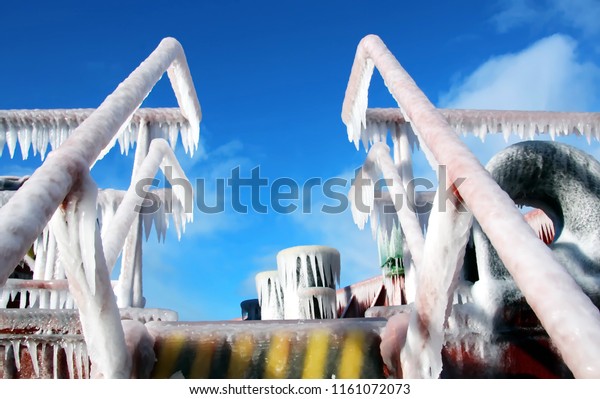 Ice of the ship and ship\
structures after sailing in frosty weather during a storm in the\
Pacific Ocean. Ice patterns and icicles, the play of light, ice and\
sun.