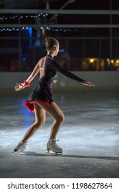 An Ice Skater Is Skating In A Circle. She Is Enjoying Her Performance. 