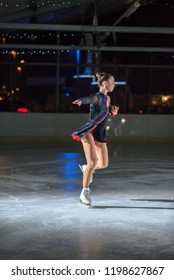 An Ice Skater Is Skating In A Circle. She Is Enjoying Her Performance. 