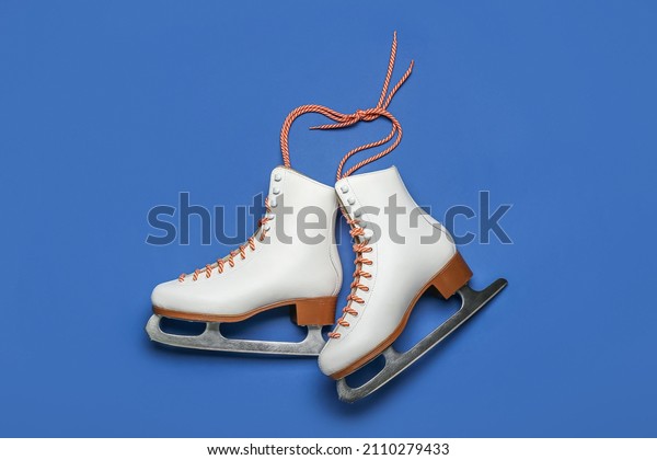 Ice skates on blue\
background