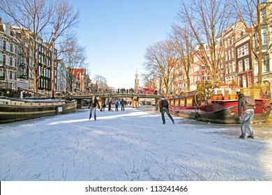 Ice skating on the canals in Amsterdam the Netherlands in winter - Powered by Shutterstock