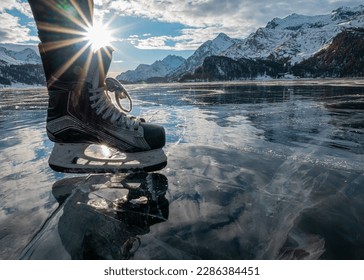 Ice skating in the sun on a frozen lake in Sils (Engadin) in the January with mountains in the background. - Powered by Shutterstock