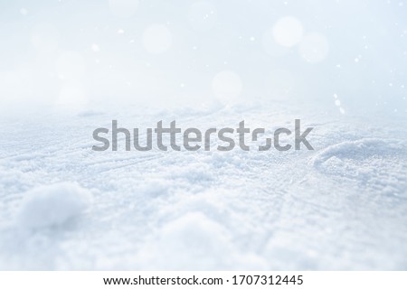 ICE AND SNOW BACKGROUND ON LIGHT BLUE BOKEH LIGHTS, COLD WINTER OR CHRISTMAS BACKDROP FOR MONTAGE PRESENTS OR FRESH PRODUCTS