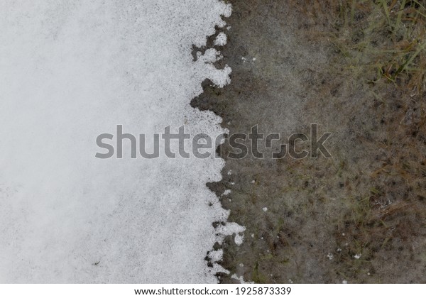 Ice and snow meeting at the center of the\
image and divides it\
vertically