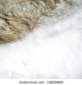 Ice And Snow Melting On Rock In Winter