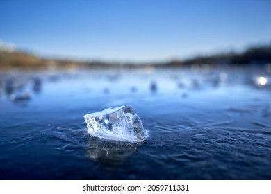 Ice Splinters Lies On A Frozen Lake. Depth Of Field, Copy Space. Deep Perspective. Winter In Germany