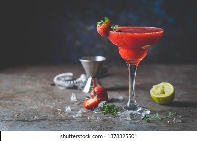 Ice Strawberry alcohol cocktail with lime and rum in a glass