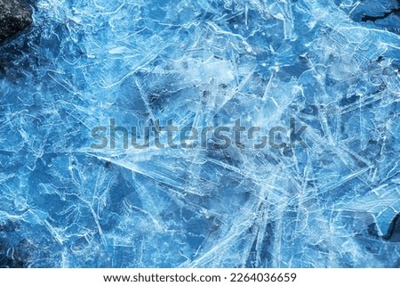 Ice surface of the river. Texture of ice shards. Winter background.