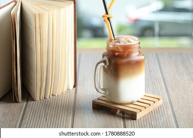 Ice Tea With Caramel Sauce And Milk In The Jar On The Table