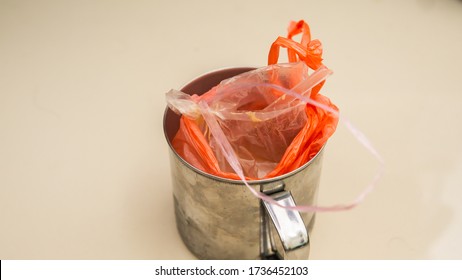 Ice Tea Drink In Plastic Bag Inside A Stainless Steel Cup Or Kole In Malay. Drinks In Bag With Tied At The Edge Of Plastic. Southeast Asian Style Serving Takeaway Drinks Out Of Plastic Bags.