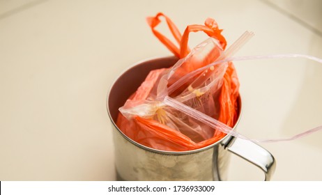 Ice Tea Drink In Plastic Bag Inside A Stainless Steel Cup Or Kole In Malay. Drinks In Bag With Tied At The Edge Of Plastic. Southeast Asian Style Serving Takeaway Drinks Out Of Plastic Bags.