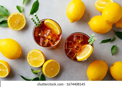 Ice tea with fresh lemons. Grey background. Close up. Top view.