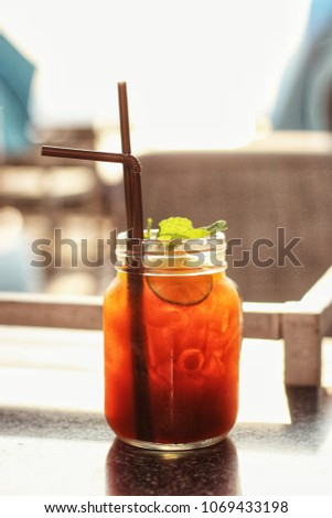 Ice tea with lemon slices and mint on a wooden table
