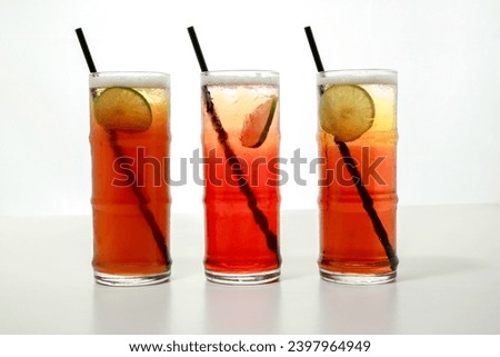ice tea with lime slice and straw served in glass isolated on grey background side view of healthy morning arabic drink