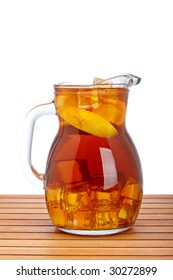 Ice Tea Pitcher With Lemon And Icecubes On Wooden Background