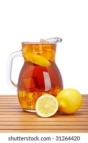 Ice Tea Pitcher With Lemon And Icecubes On Wooden Background