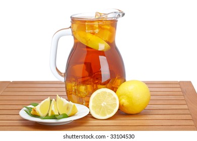 Ice Tea Pitcher With Lemon And Icecubes On Wooden Background