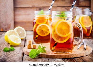 ice tea with slice of lemon in mason jar on the wooden rustic background