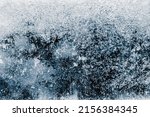 Ice texture background. The textured cold frosty surface of ice block on dark background.