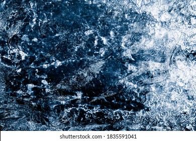 Ice Texture Background. The Textured Cold Frosty Surface Of Ice Block On Dark Background.